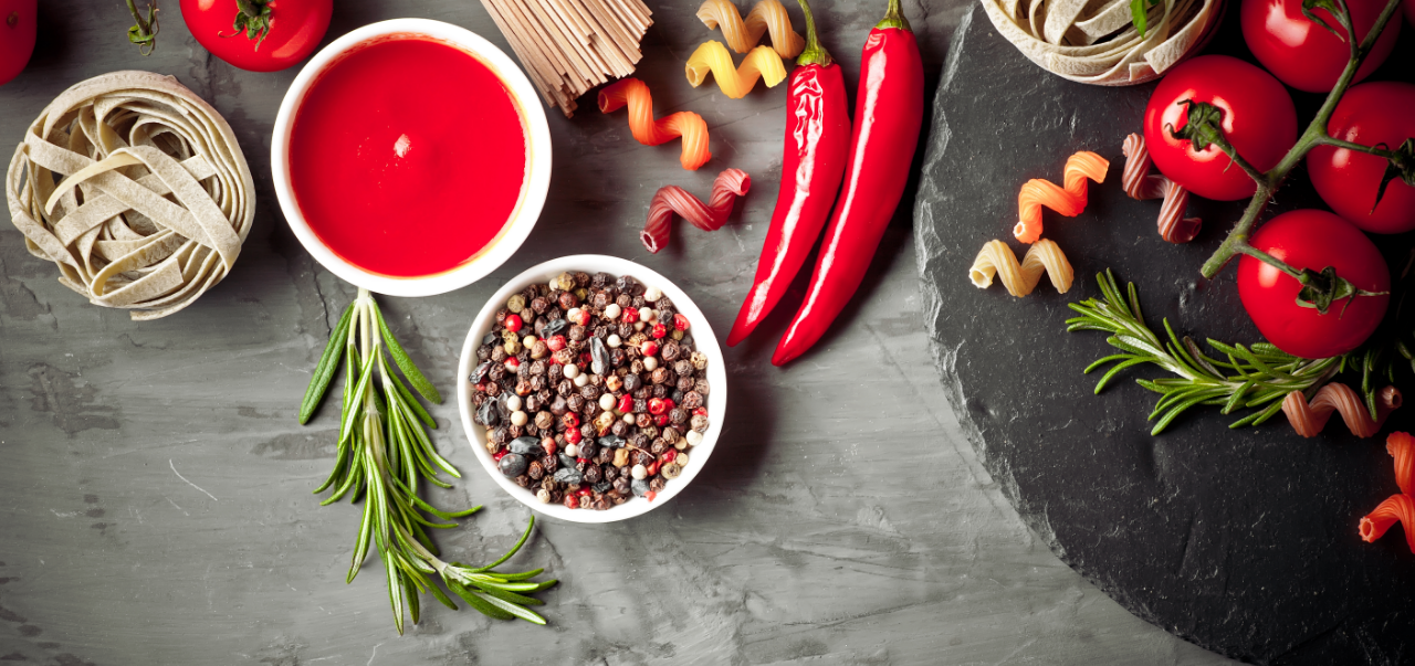 Pasta in a composition with vegetables and kitchen accessories. Food ingredients flat lay.