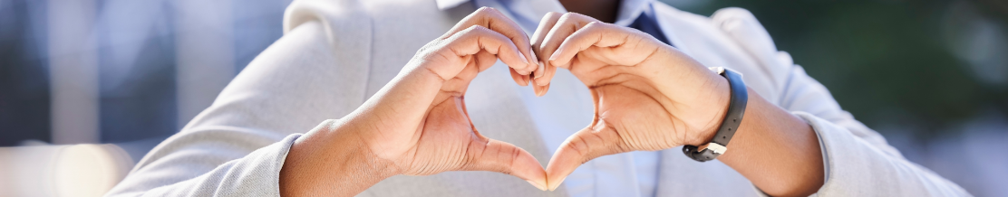 Black, corporate office worker making a love gesture with her fingers.